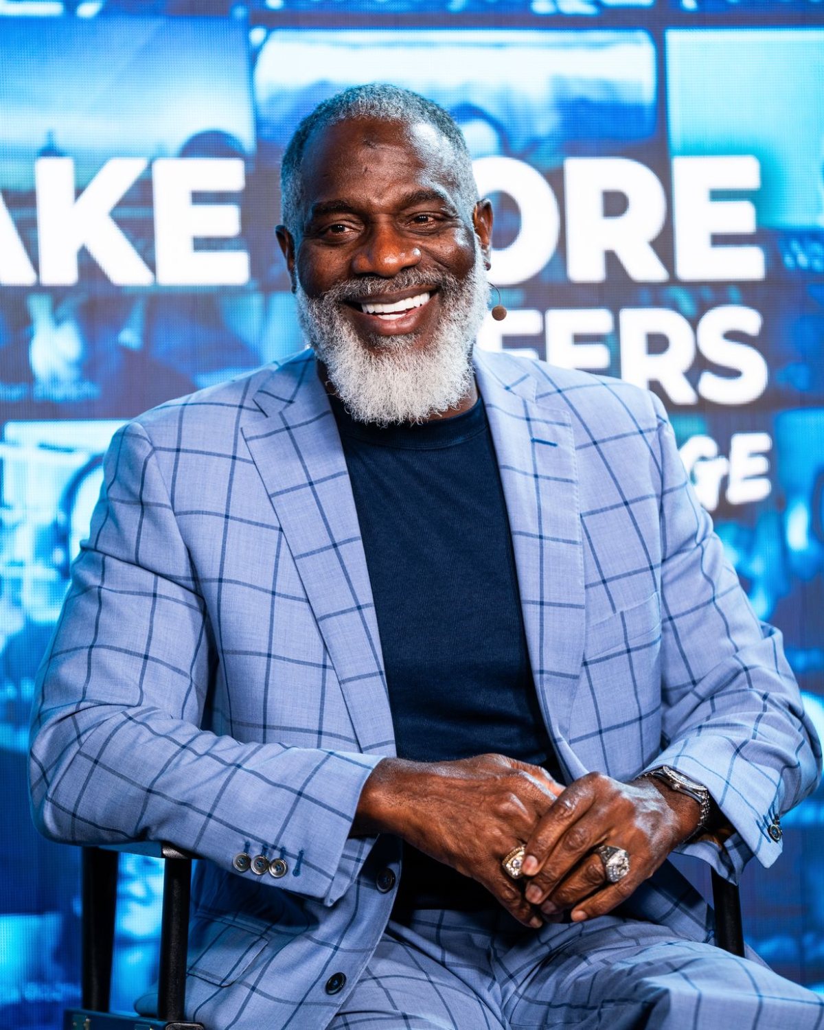 Myron Golden smiling, seated on stage