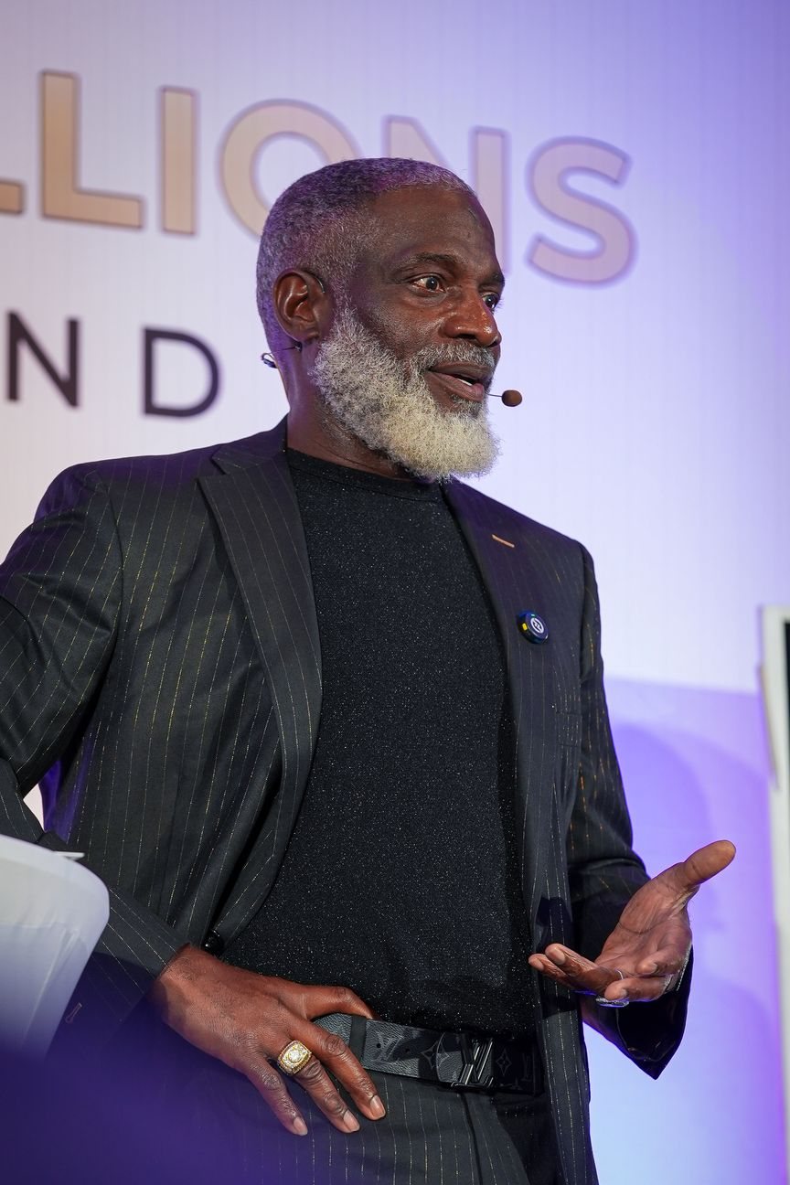 Myron Golden speaking on stage