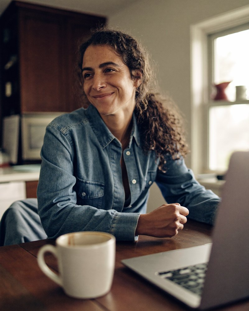 A first-time novelist at her kitchen table with a laptop